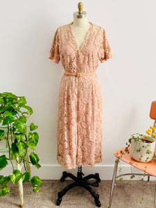vintage 1940s pink lace dress with matching belt on mannequin