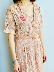 model wearing vintage 1940s pink lace dress with matching belt and brooch