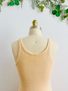 back detail of 1920s peach color wool slip dress on mannequin