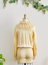 Load image into Gallery viewer, back view of a mannequin display a vintage beige color satin blouse with lace ruffled collar
