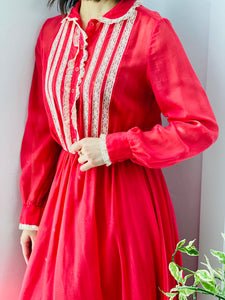 model wearing a 1970s red color lace dress 