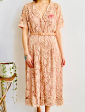 Load image into Gallery viewer, model wearing vintage 1940s pink lace dress with matching belt and brooch 
