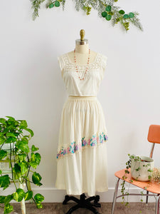 mannequin displays embroidered details on a vintage 1970s white cotton skirt with 1910s lace top