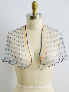 mannequin display a 1940s ruffled polka dot scarf