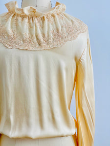back lace detail of a beige vintage satin blouse 