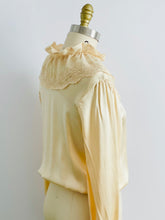 Load image into Gallery viewer, shoulder view of a mannequin display a vintage beige color satin blouse with lace ruffled collar
