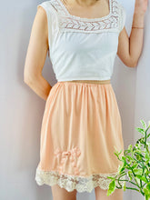 Load image into Gallery viewer, peach color 1930s nylon skirt on model 
