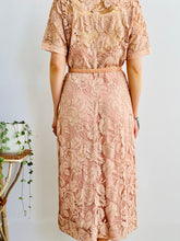 Load image into Gallery viewer, full length of back side view of model wearing 1940s pink lace dress with belt 
