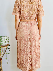 full length of back side view of model wearing 1940s pink lace dress with belt 