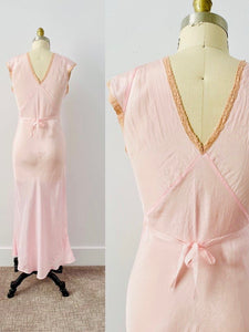 back side of a 1930s pink lingerie dress on mannequin