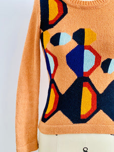 art deco pattern on a vintage orange sweater 