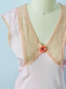 details of a vintage 1930s lingerie dress with ribbon flower and lace 