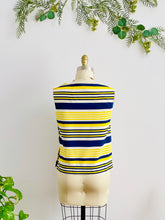 Load image into Gallery viewer, back side of a 1960s yellow and blue striped top with side square buttons on mannequin
