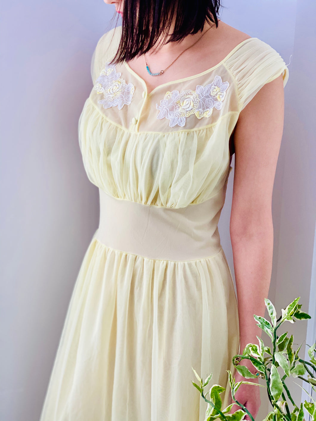 1960s Yellow sheer lingerie gown with embroidered flowers on model