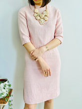 Load image into Gallery viewer, model wearing a 1940s pink linen two piece set with large pearl necklace 

