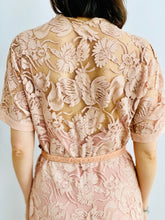 Load image into Gallery viewer, back side view of model wearing 1940s pink lace dress with belt 
