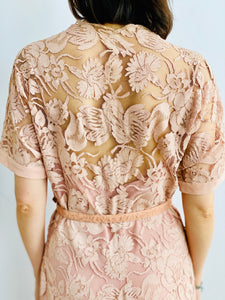 back side view of model wearing 1940s pink lace dress with belt 