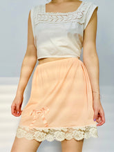 Load image into Gallery viewer, 1910s lace top and peach color ribbon bow lace nylon skirt on model
