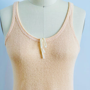 closeup of 1920s peach color wool slip dress on mannequin