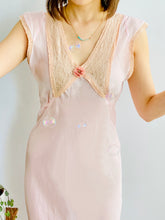Load image into Gallery viewer, model wearing a vintage 1930s pink lingerie dress with lace and ribbon having fun with soap bubbles
