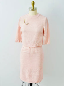 mannequin display a 1940s pink linen two piece set with flapper and dog brooch