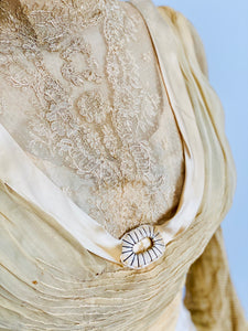 front lace detail of an antique top with silk buckle