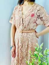 Load image into Gallery viewer, model wearing 1940s vintage pink lace dress with matching belt and pink brooch
