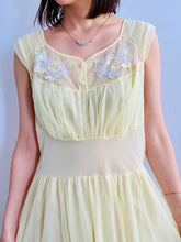 Load image into Gallery viewer, 1960s Yellow sheer lingerie gown with embroidered flowers on model
