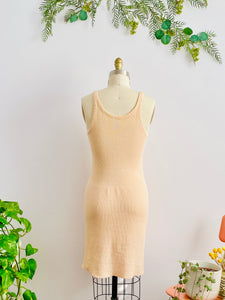 back side of 1920s peach color wool slip dress on mannequin