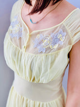 Load image into Gallery viewer, closeup of a 1960s Yellow sheer lingerie gown with embroidered flowers on model
